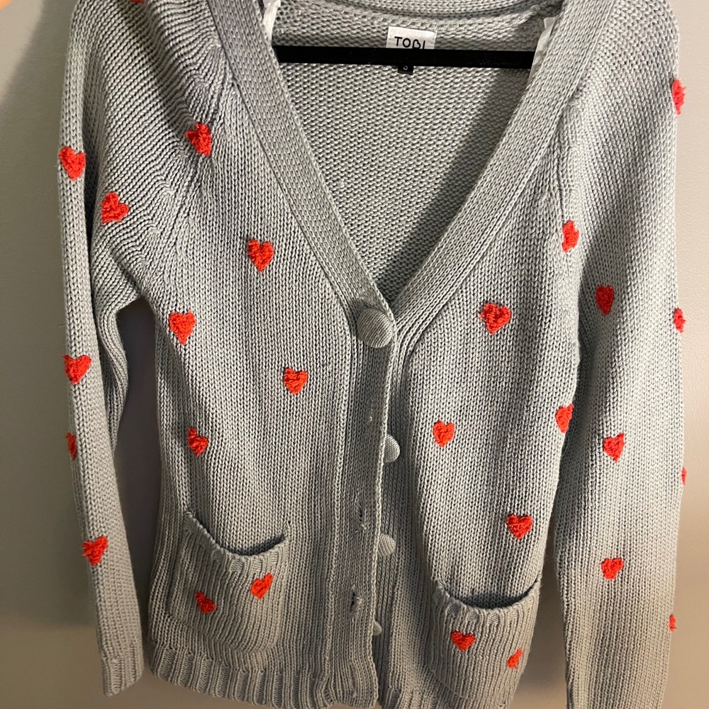 Grey cardigan with red hearts